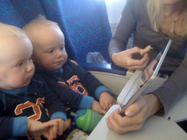 Crianças entretidas com um iPad em um avião