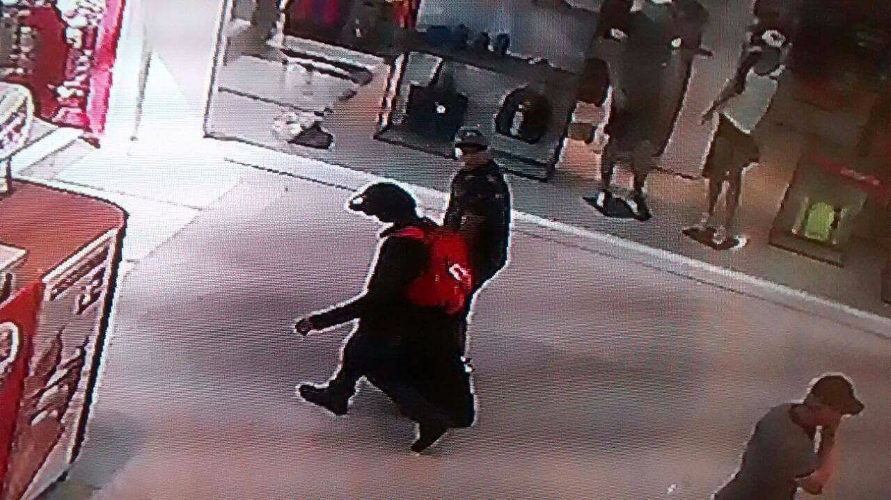 Assaltantes com produtos roubados de uma loja iPlace, no Shopping Pelotas