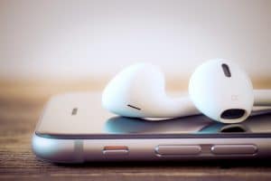 Close de iPhone com fones de ouvido EarPods ou AirPods