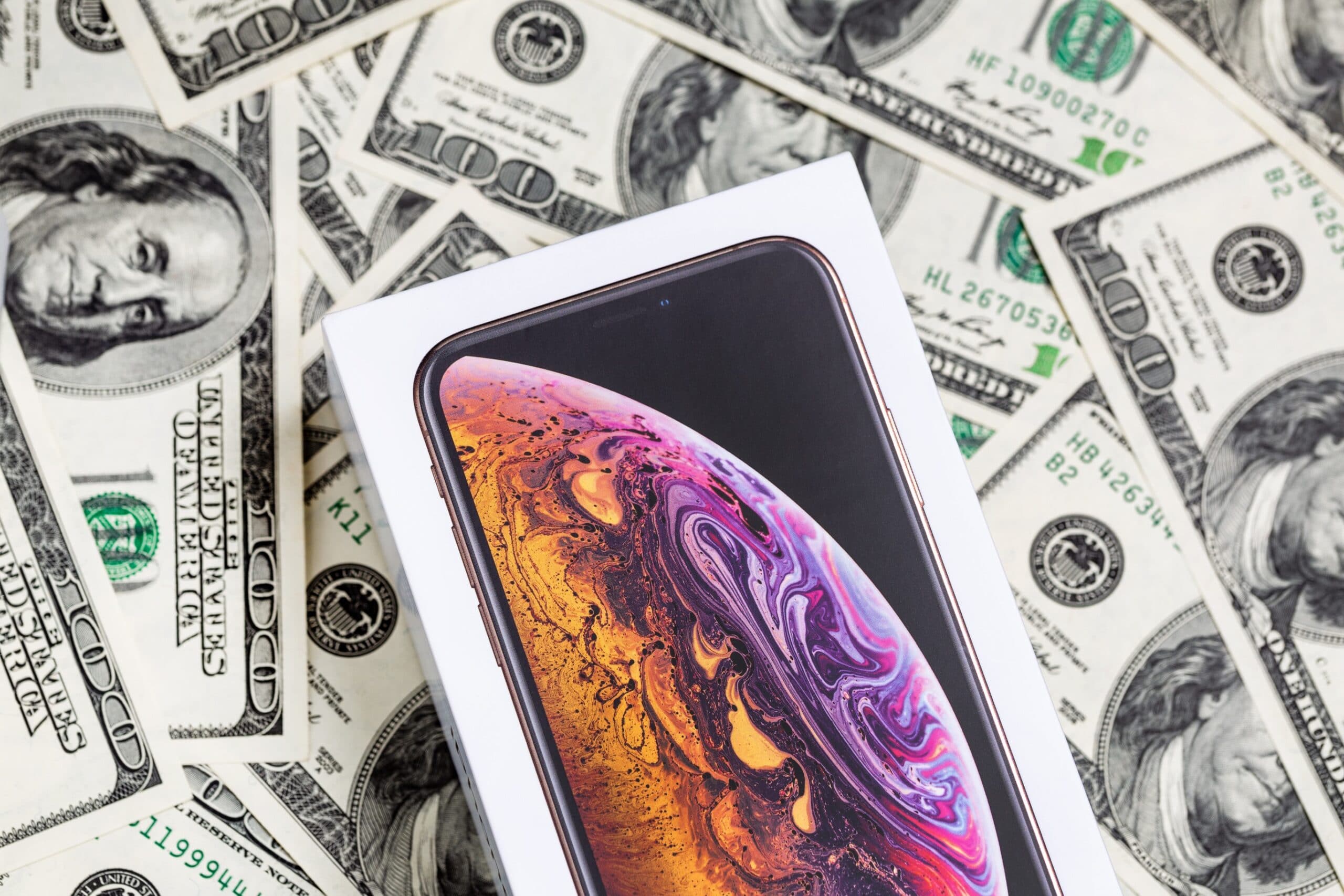 iPhone em cima de notas de dólar