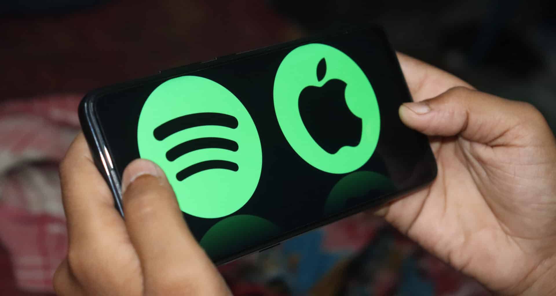 Logos da Apple e do Spotify em um smartphone