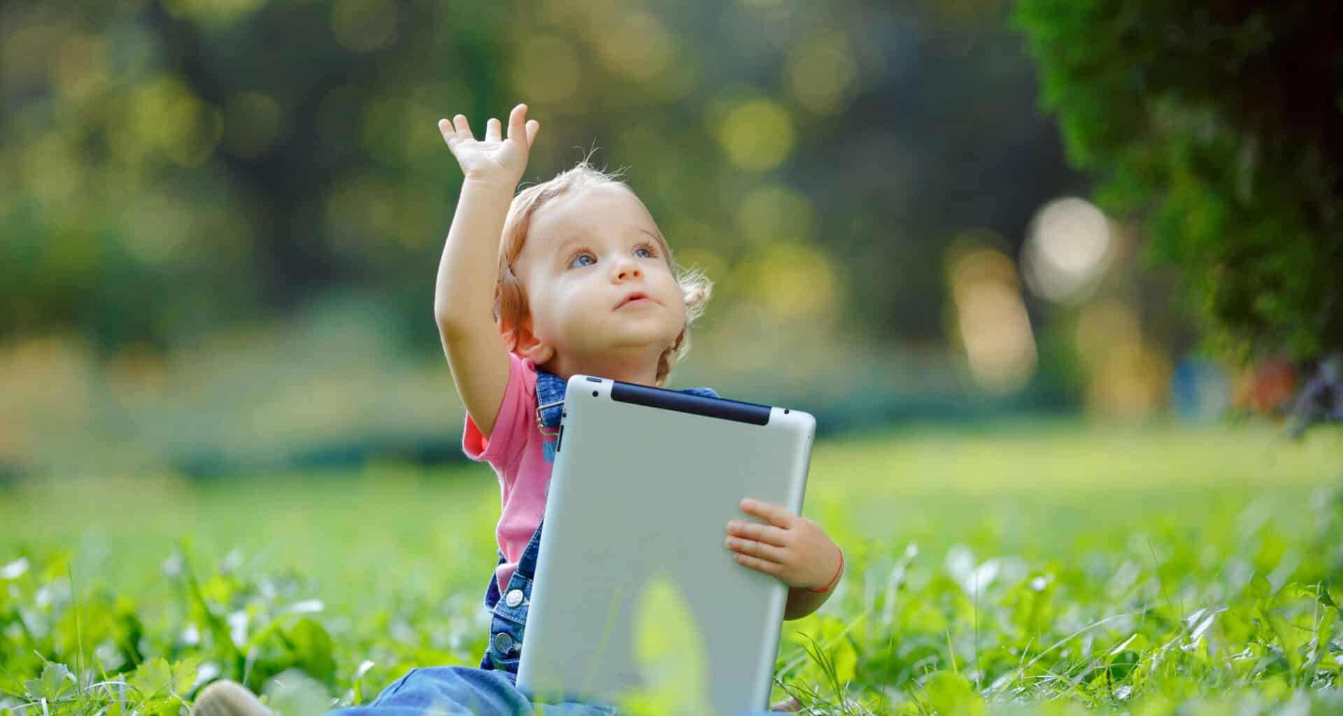 Criança com iPad num parque