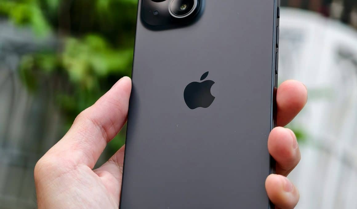 Mão segurando um iPhone 15 preto